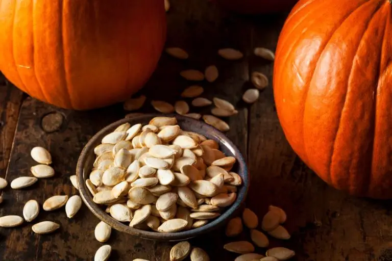 Crispy old-fashioned roasted pumpkin seeds in a pottery bowl.