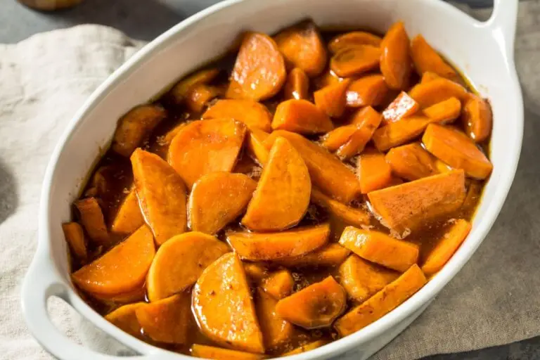 Orange glazed sweet potatoes in a white casserole dish