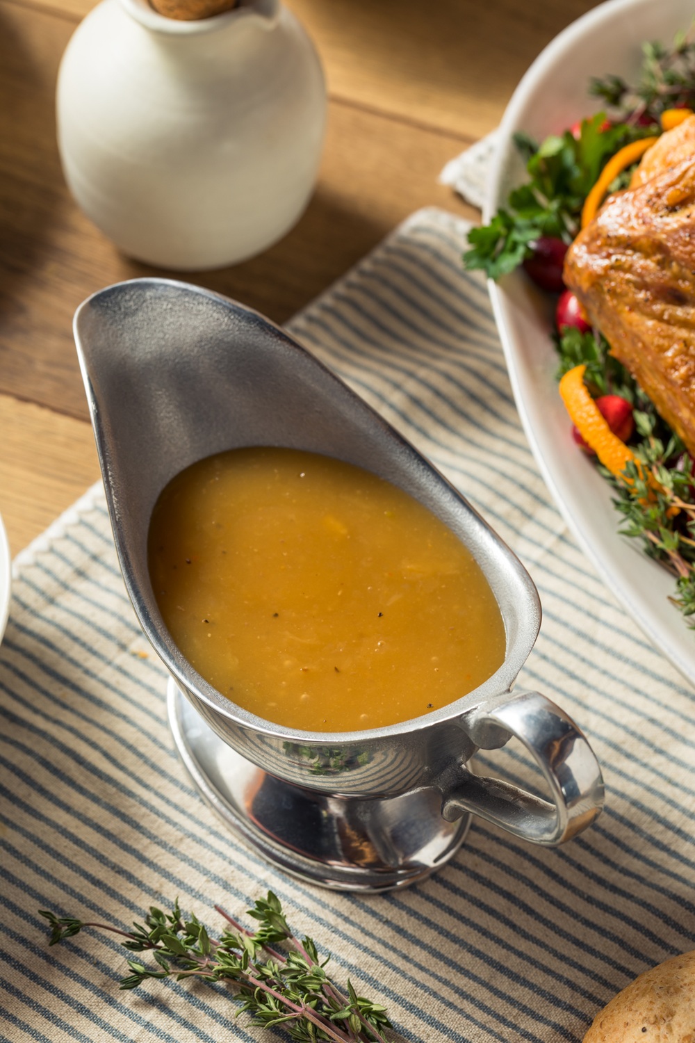 Close up of turkey giblet gravy in a silver gravy boat