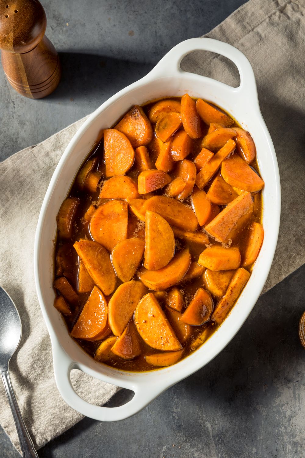 Orange glazed sweet potatoes in a white casserole dish