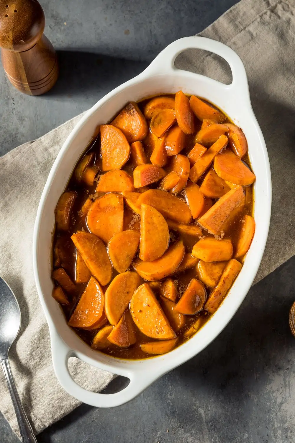 Orange glazed sweet potatoes in a white casserole dish