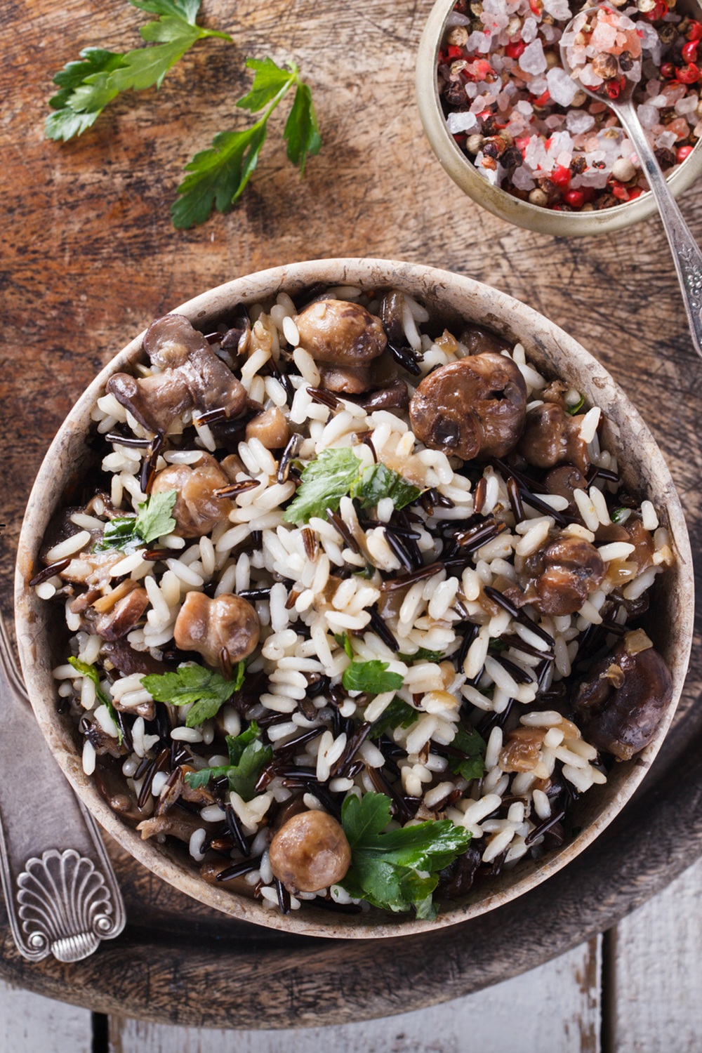 Wild rice and mushrooms in a pottery bowl.