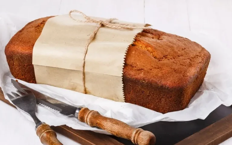 Loaf of old-fashioned pumpkin bread wrapped in parchment for gifting.