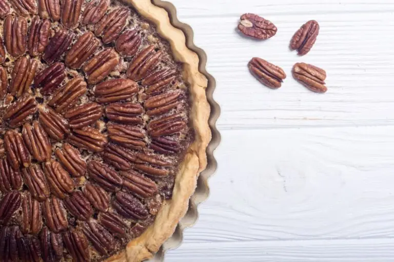 Homemade pecan pie in a scalloped pie plate