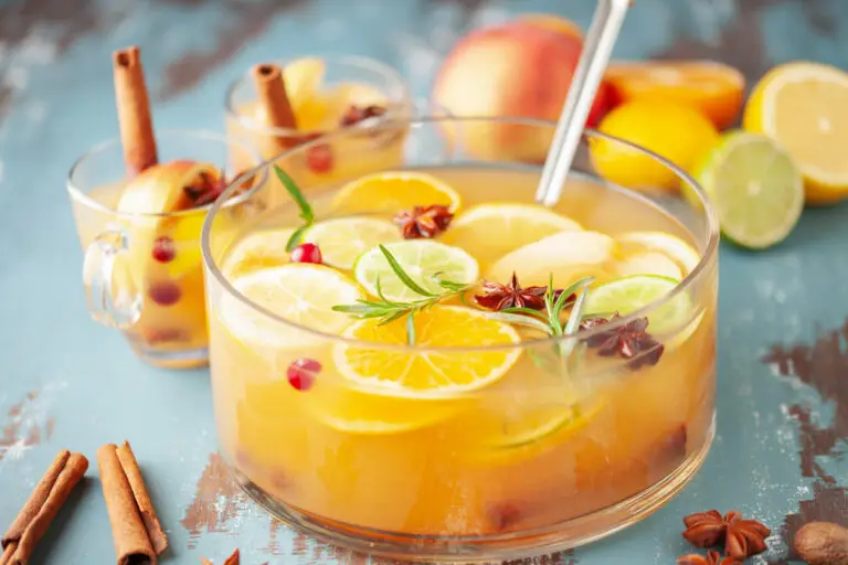 Apple cider punch bowl garnished with orange slices.