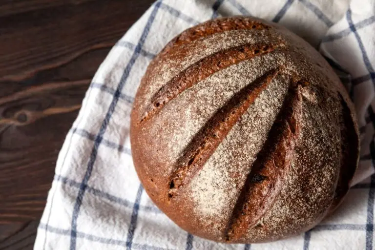 Decorative round loaf of dark pumpernickel bread