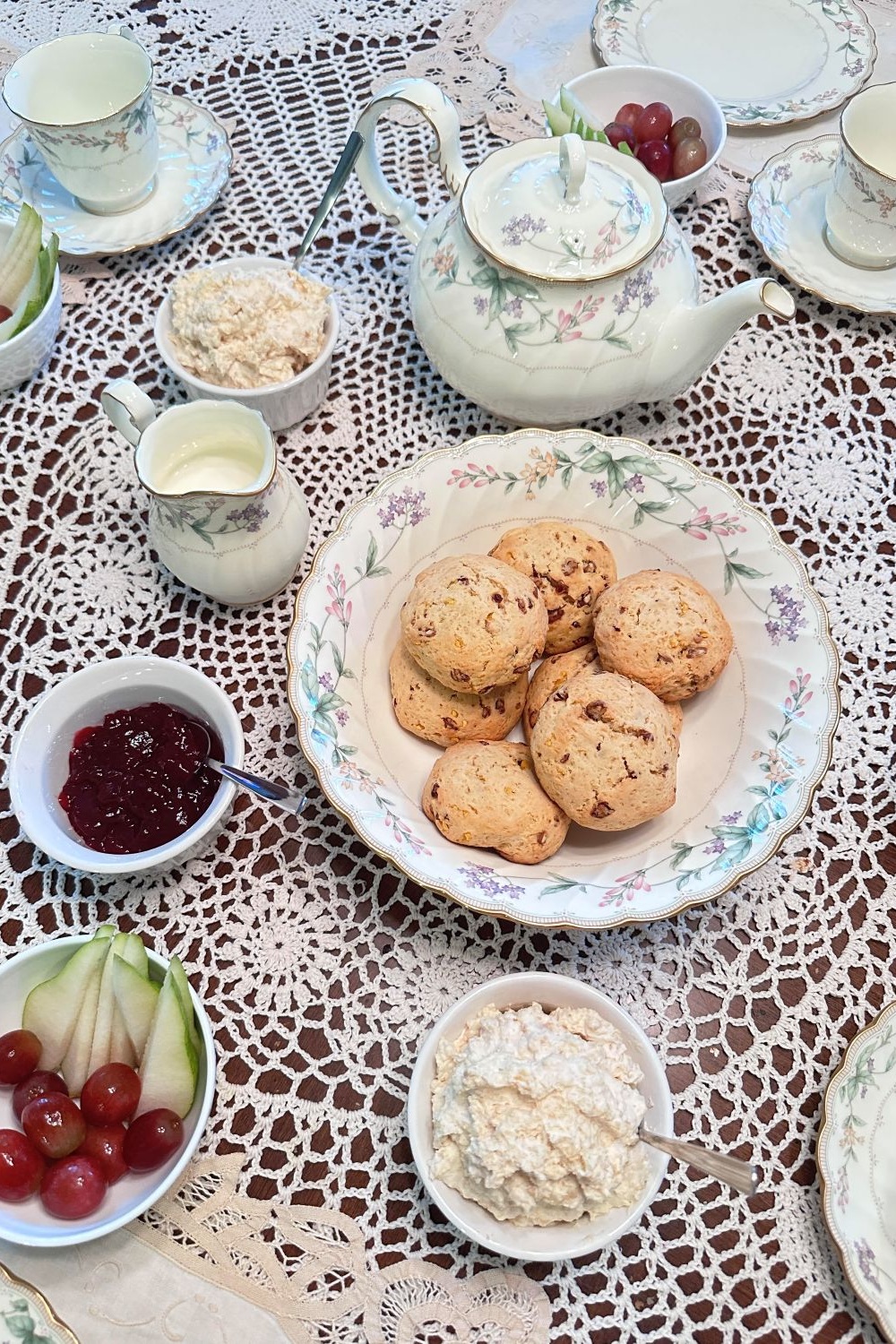 Table set with scones, jam, and homemade clotted cream.