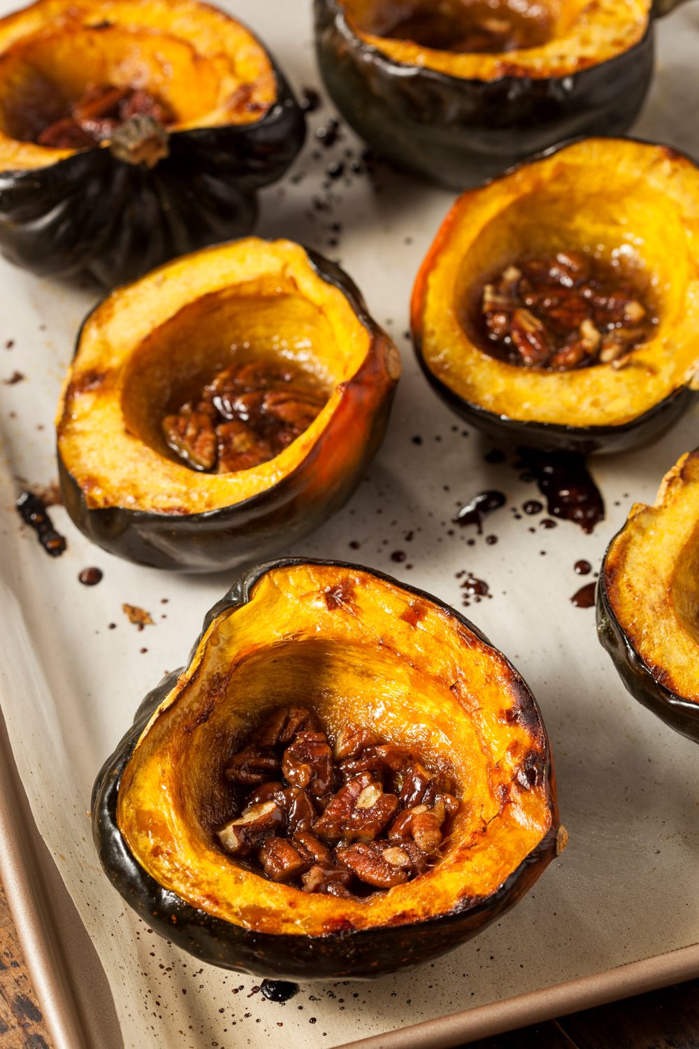 Baked acorn squash with butter and cinnamon dressed with toasted pecans