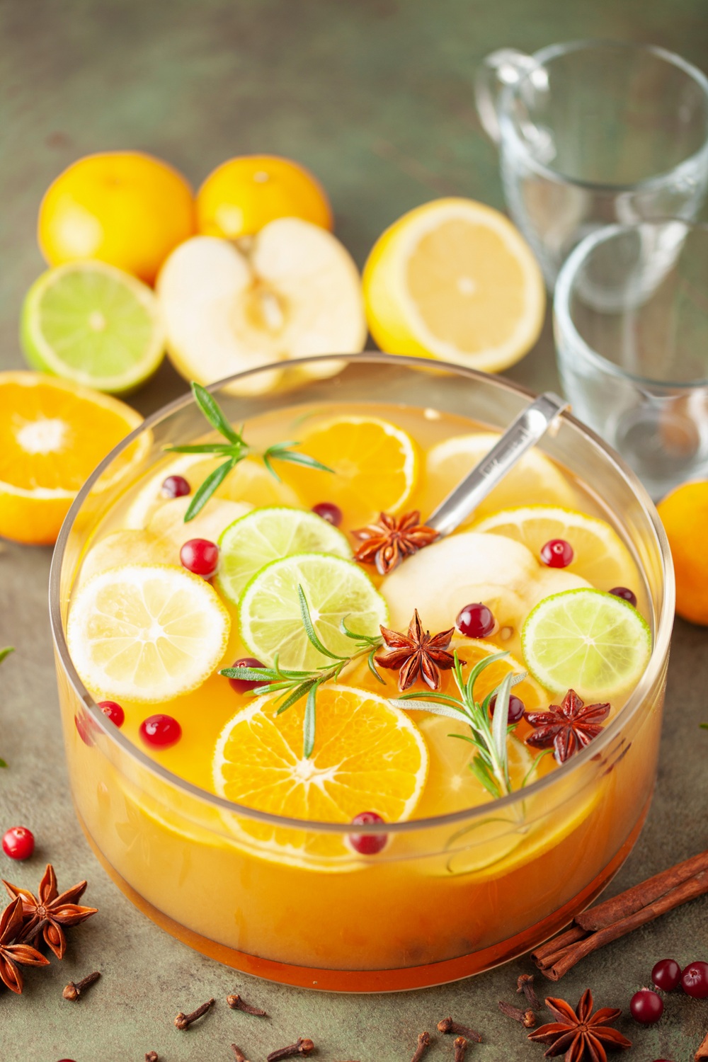 Apple cider punch garnished with orange and lime slices