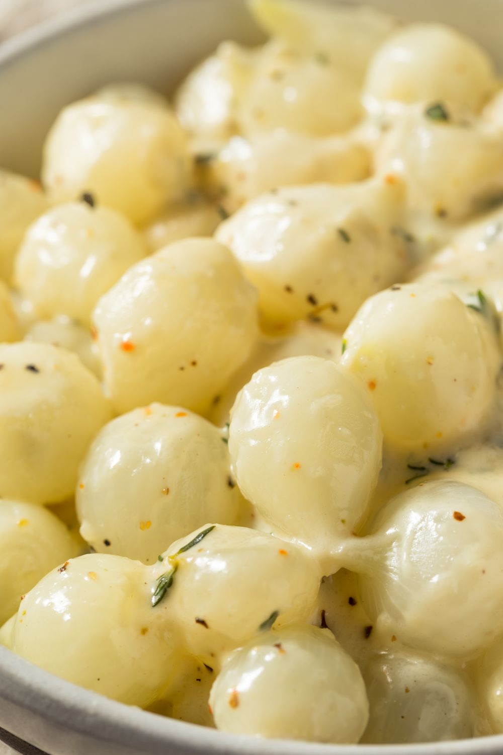 Creamed pearl onions seasoned with nutmeg and thyme.