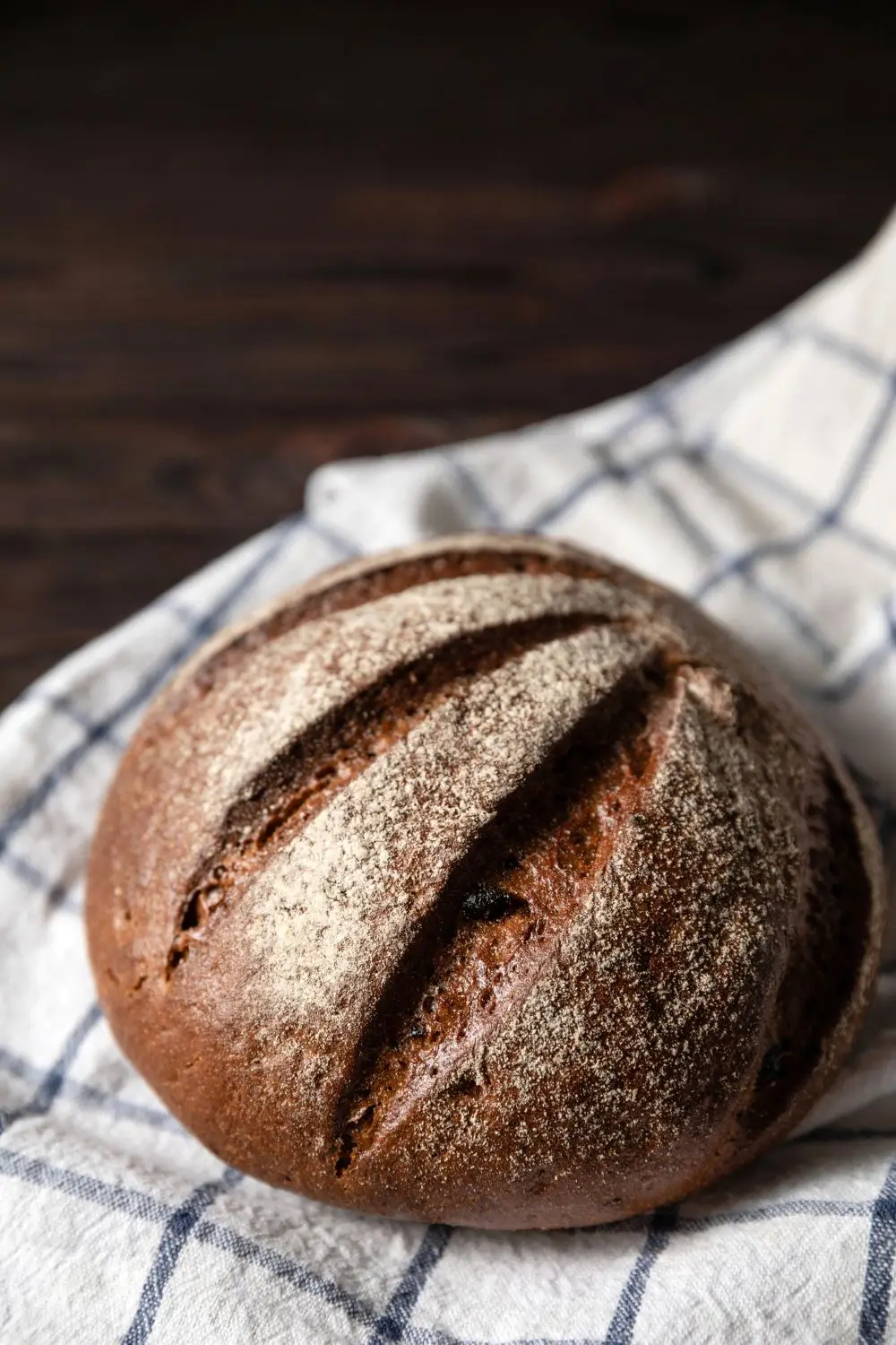 Decorative round loaf of dark pumpernickel bread