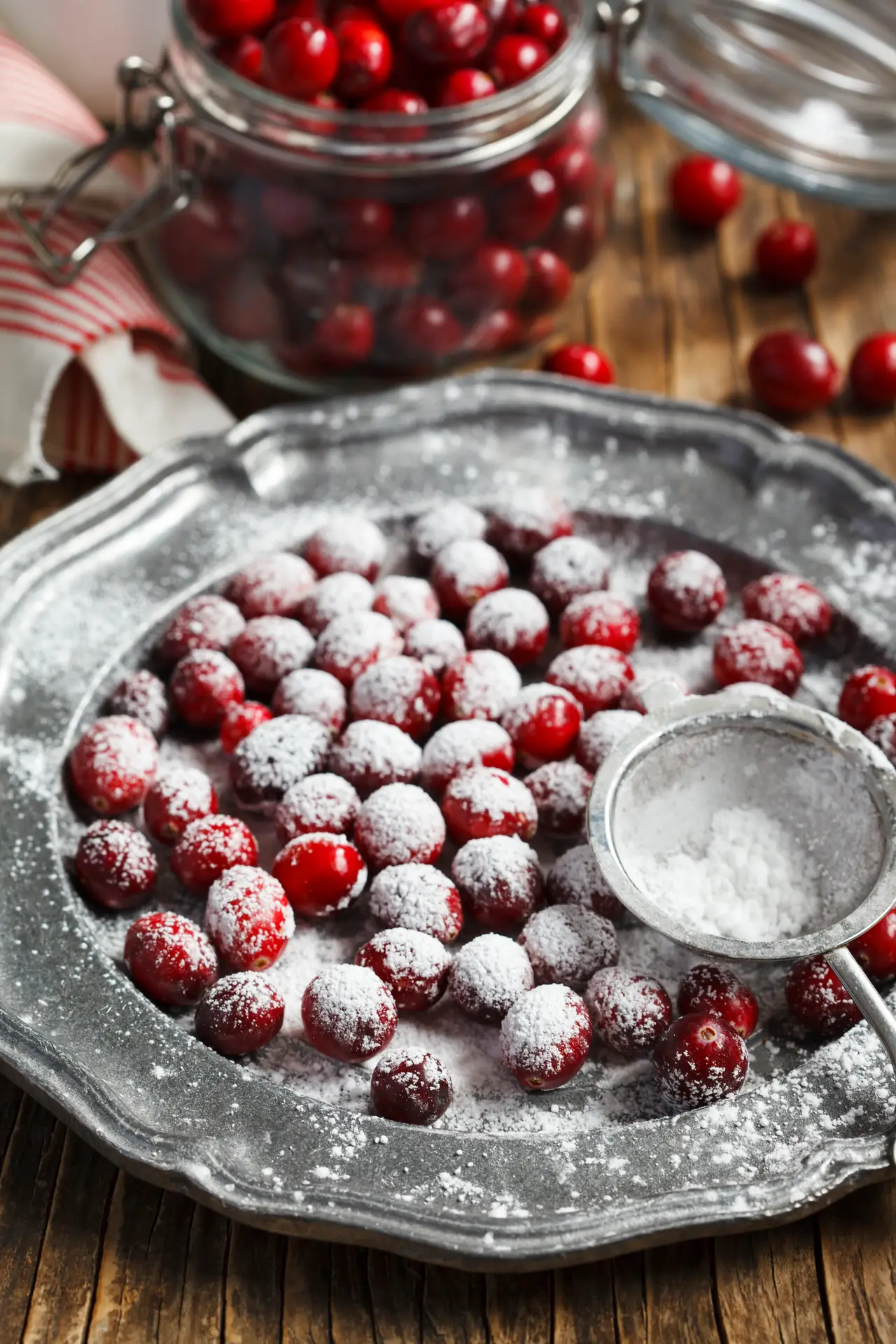 Cranberries covered in powdered sugar on a silver platter
