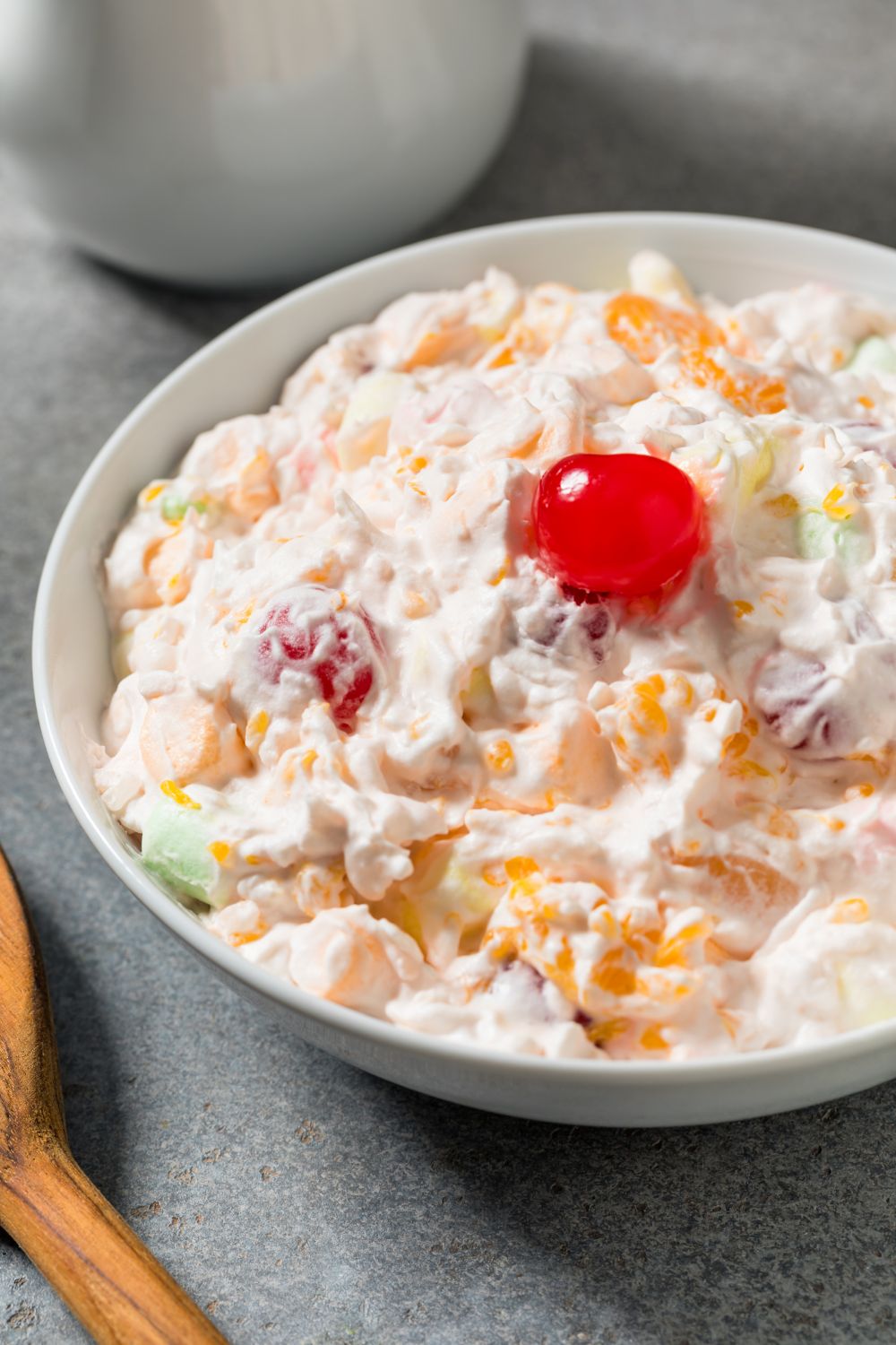 Classic ambrosia fruit salad in small white bowl