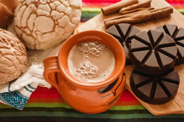 Homemade Mexican hot chocolate using Mexican chocolate tablets, served with conchas.