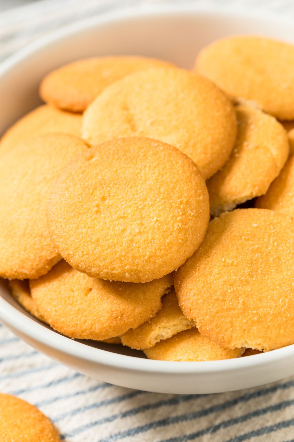 Homemade vanilla wafers in a white bowl.