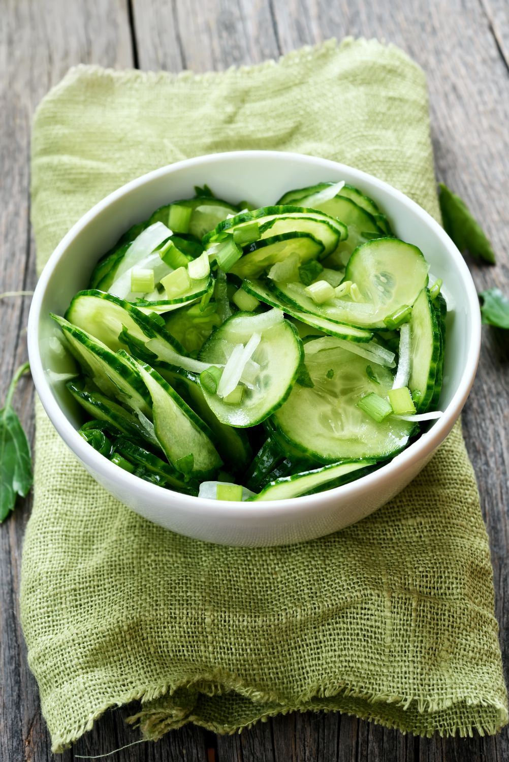 Cucumber salad in white bowl