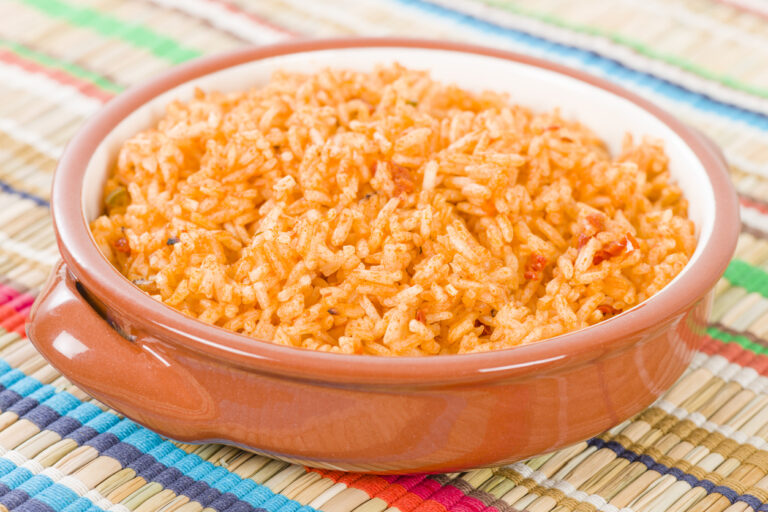 A bowl of authentic Mexican red rice (arroz rojo) with fluffy, deep tomato-colored long grain rice, adapted from Diana Kennedy's 1979 recipe