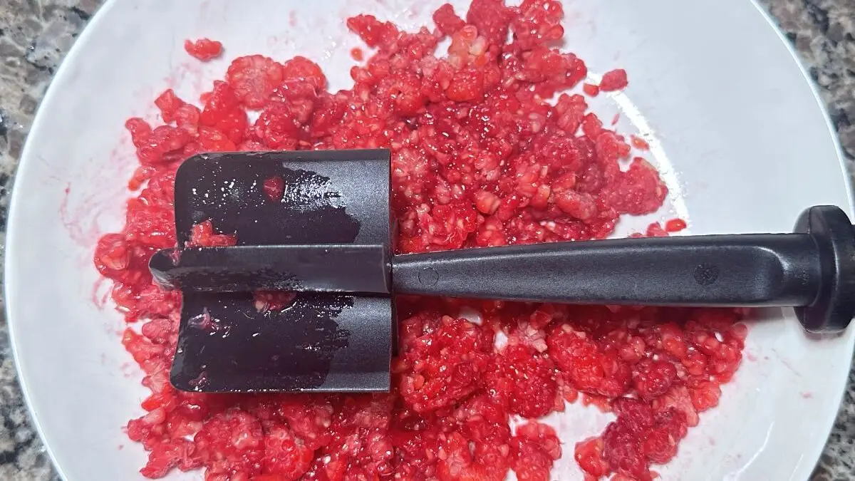 Crush fresh raspberries for vintage circus pink lemonade