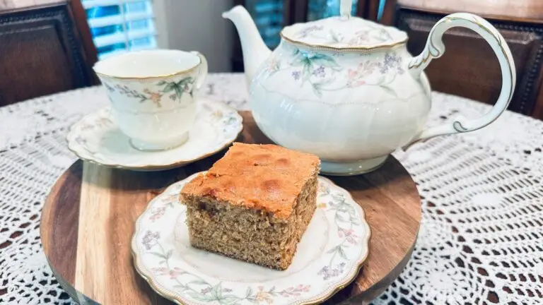 old fashioned spice cake recipe with bacon drippings sliced into a square on a wooden cake stand