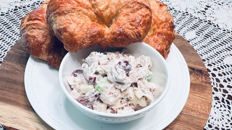 bowl of waldorf chicken salad with a croissant