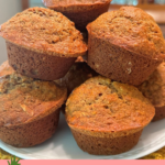stack of pineapple banana bread muffins on a wooden cake stand