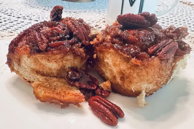 pecan sticky buns with caramel topping on a white plate