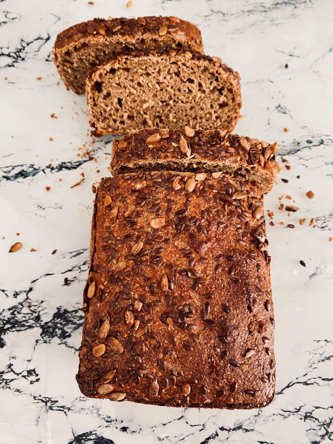 sliced einkorn bread on a white marble slab