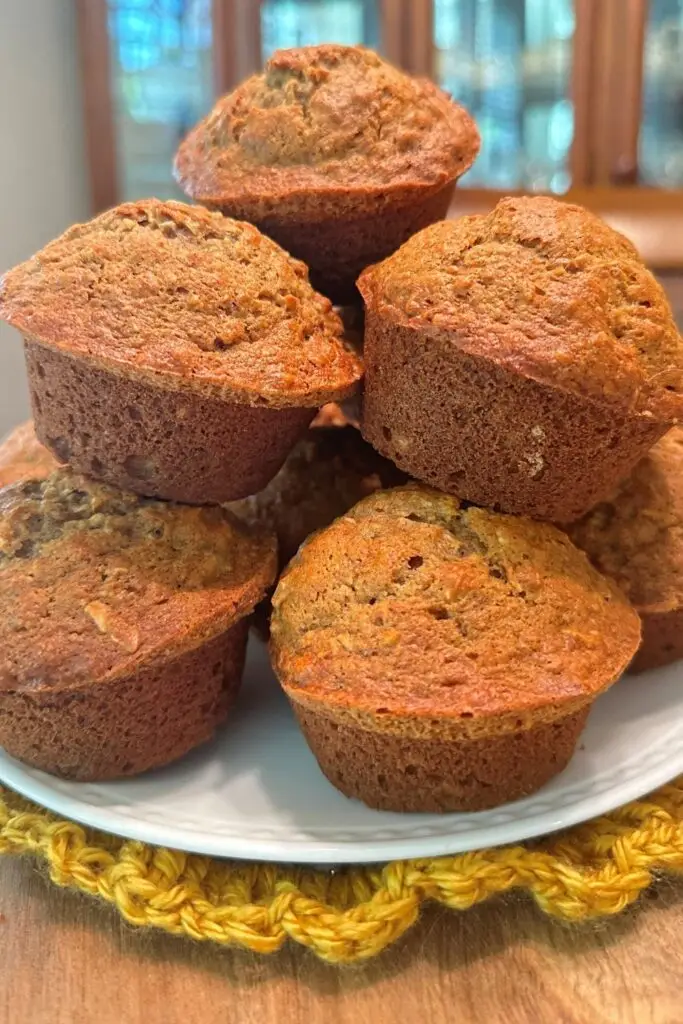 stack of pineapple banana bread muffins on a wooden cake stand